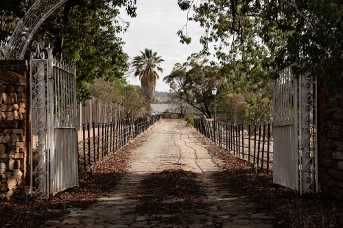 Old iron gates leading into a property - Australian Stock Image