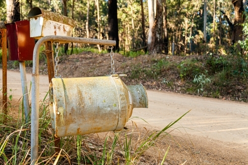 Old milk can as country mailbox at property entrance - Australian Stock Image