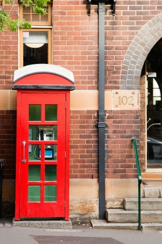 old red phone box - Australian Stock Image