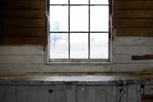 Old window with wooden cladding inside old shed - Australian Stock Image