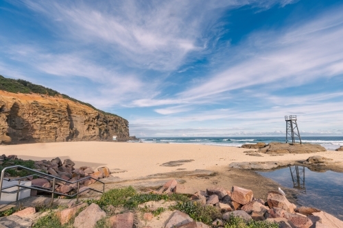 Old wooden lifeguard, shark lookout tower on Redhead Beach with reflection - Australian Stock Image