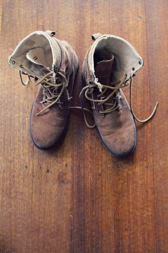 Old worn mens boots from overhead with copy space - Australian Stock Image