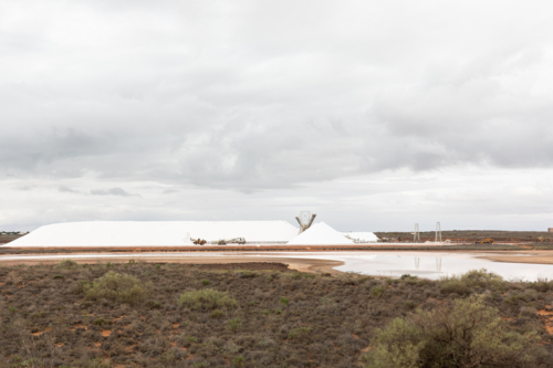 Onslow Salt piles ready for shipping in Onslow WA on a stormy day - Australian Stock Image