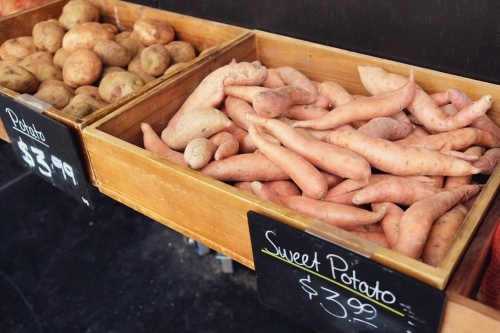 Organic sweet potato in wooden box - Australian Stock Image