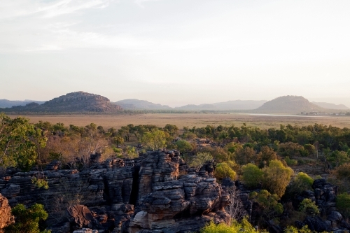 Outback landscape with rocky cliffs, trees and mountains - Australian Stock Image