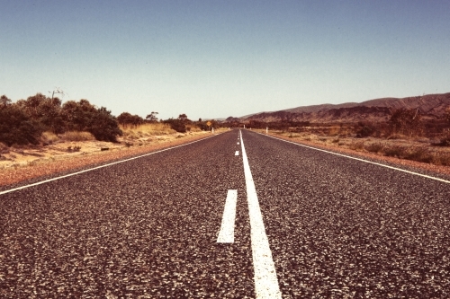 outback road with white lines on a hot day in a rural area - Australian Stock Image