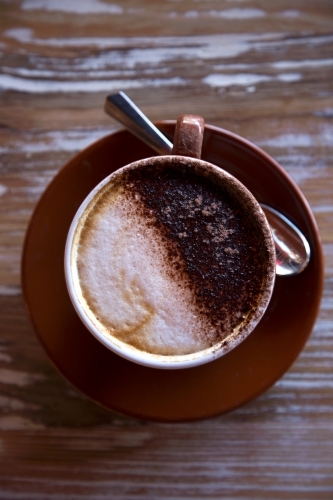 Overhead shot of freshly made coffee with wooden background - Australian Stock Image