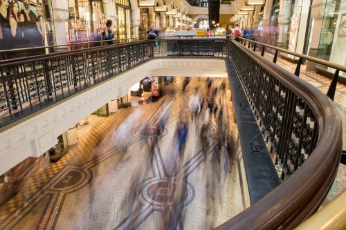 Overlooking commuters and shoppers blurred in motion at the Queen Victoria Building