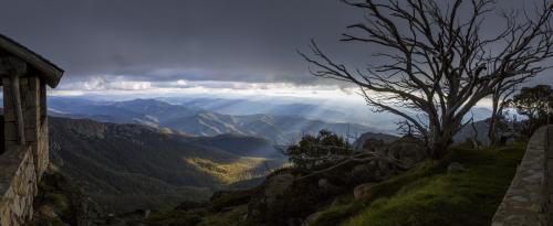 Panorama view of sun rays shining on valleys and mountains