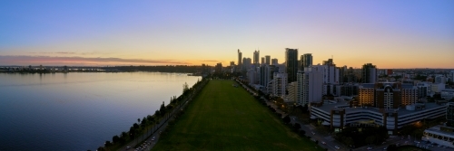 Panoramic aerial view of Perth City at twilight, with the Swan River and Langley Park in view.