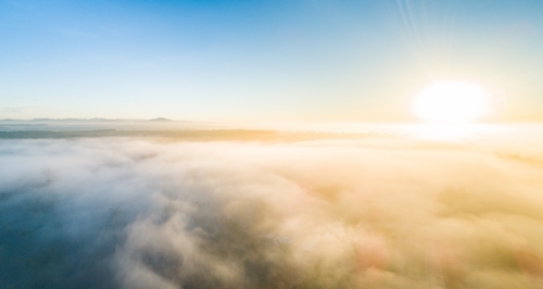 Panoramic landscape of misty sunrise over thick fog - Australian Stock Image