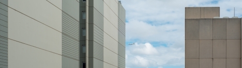 Panoramic of office buildings with cloudy sky behind - Australian Stock Image