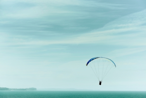 Paragliding into a beautiful sky alone - Australian Stock Image