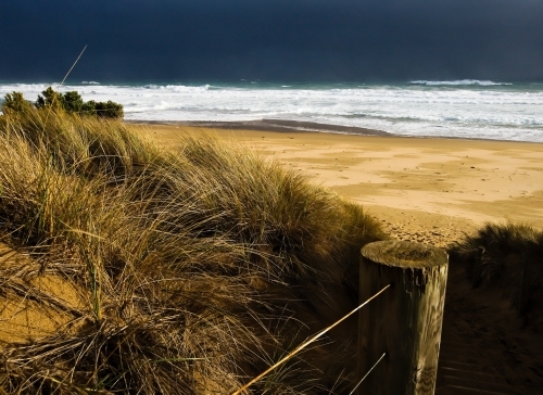 path to remote beach with storm approaching - Australian Stock Image