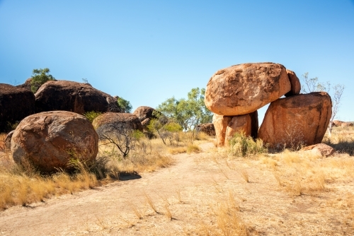 Pathway to large rock formations that are sitting on top of each other. - Australian Stock Image