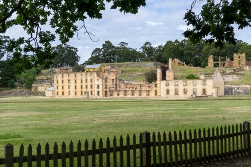 Penitentiary at Port Arthur framed by picket fence and trees - Australian Stock Image