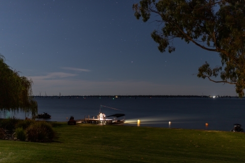 People fishing at night on lake - Australian Stock Image