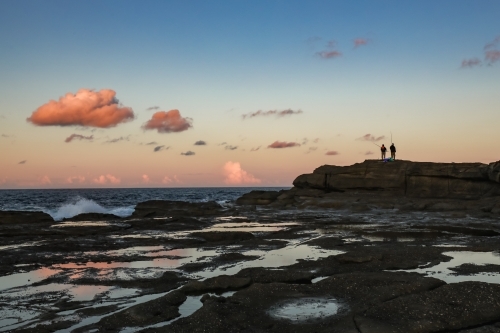 People fishing from rocks at Norah Head, New South Wales Australia - Australian Stock Image