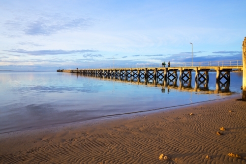 People walking along jetty late afternoon - Australian Stock Image