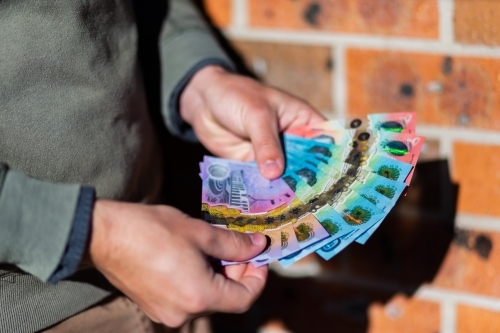 Person fanning out money, new australian cash notes - Australian Stock Image