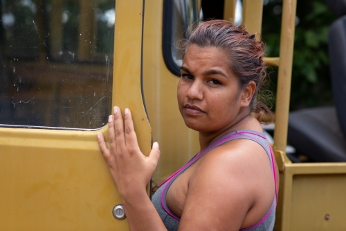 person getting into passenger door of old vehicle - Australian Stock Image