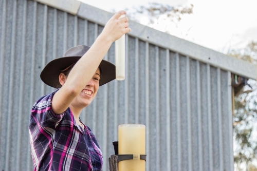 Person measuring rain in rain gauge - Australian Stock Image