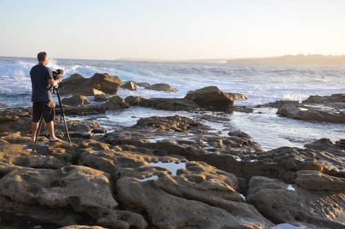 Photographer on rocks - Australian Stock Image