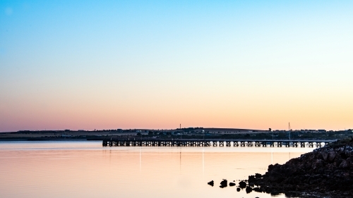 Pier in the distance during the early hours of dawn. - Australian Stock Image