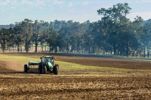 Planting a crop with tractor and seed drill - Australian Stock Image