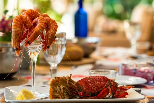 plate of seafood on a table set for a celebration meal - Australian Stock Image