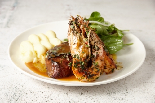 Plate of surf n turf - steak and prawns - Australian Stock Image