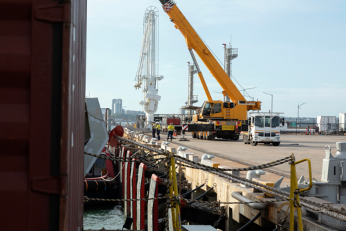 Port loading with crane and workmen - Australian Stock Image