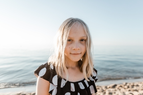 Portrait of a girl at the beach looking at the camera - Australian Stock Image