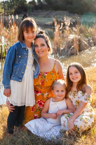 Portrait of a happy mother with her young daughters - Australian Stock Image