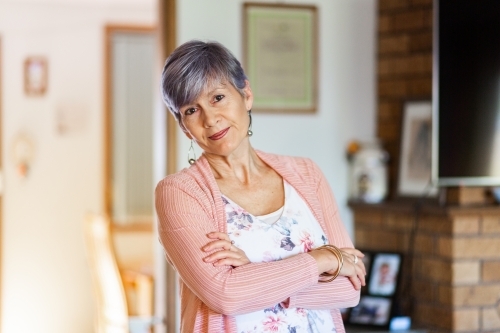 Portrait of a happy senior woman in her living room - Australian Stock Image