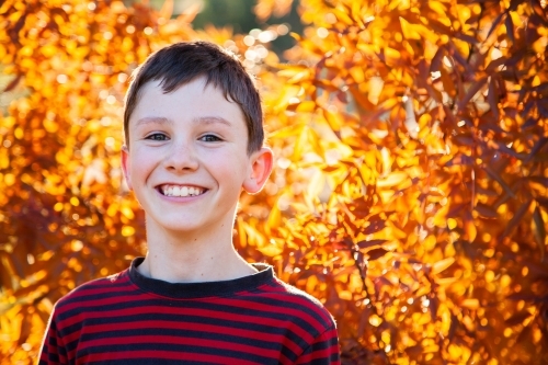 Portrait of a happy ten year old in autumn - Australian Stock Image