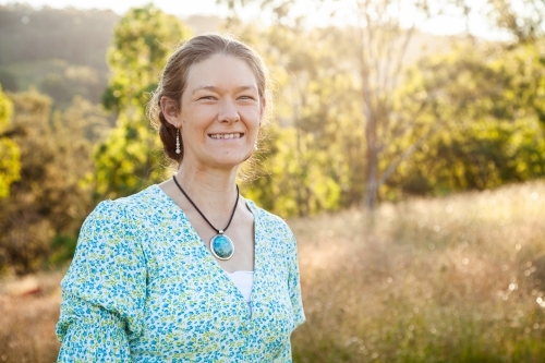 Portrait of a happy woman outside in paddock - Australian Stock Image