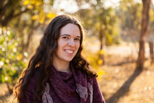 Portrait of a happy young brunette woman outside in winter - Australian Stock Image