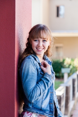 Portrait of a happy young woman in urban setting - Australian Stock Image