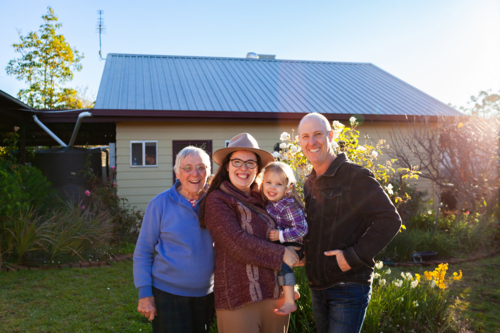 Portrait of a multi-generation family standing in the garden - Australian Stock Image