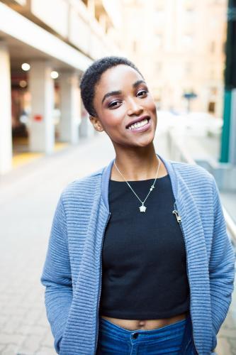 Portrait of a smiling woman walking in the city - Australian Stock Image