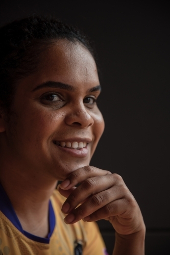 Portrait of Aboriginal woman with black background - Australian Stock Image