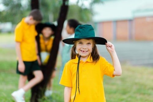 Portrait of Aussie child at public school with sun hat on - Australian Stock Image