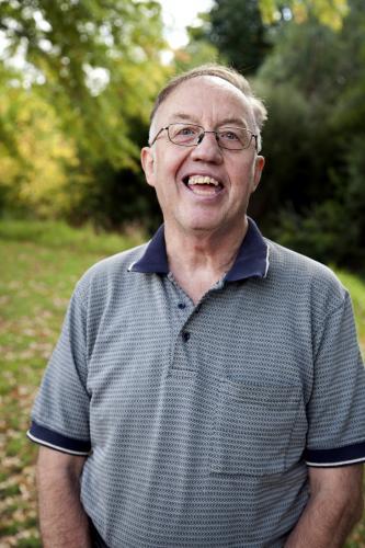 Portrait of happy man with a disability standing outside