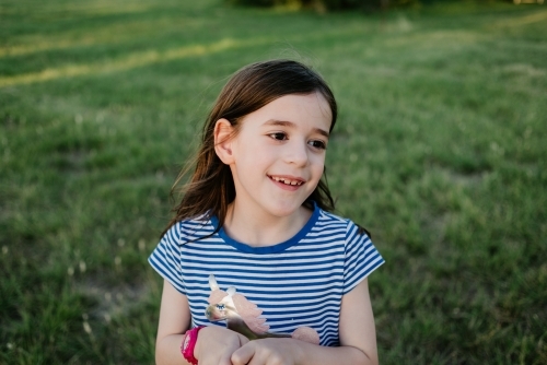 Portrait of happy young girl in the park at sunset - Australian Stock Image