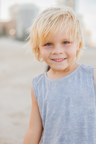 Portrait of little boy smiling on the beach - Australian Stock Image