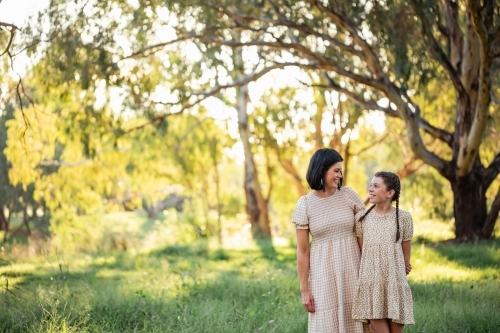 Portrait of mother and daughter standing together in Australian bush setting - Australian Stock Image