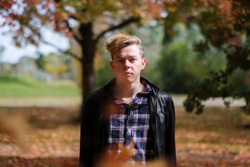 Portrait of serious young man in outdoor setting - Australian Stock Image