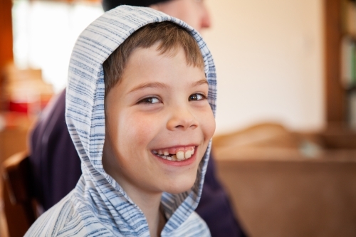 Portrait of smiling brown eyed boy in hoodie - Australian Stock Image