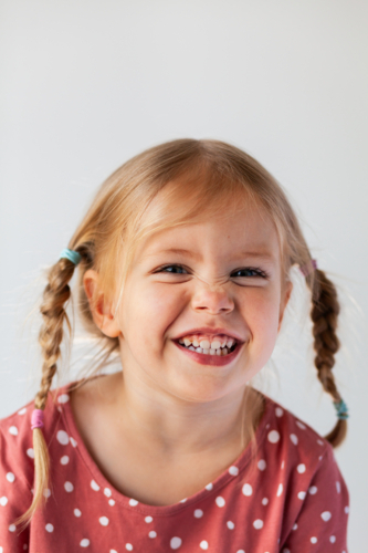 Portrait of smiling young Australian Caucasian child on white backdrop - Australian Stock Image